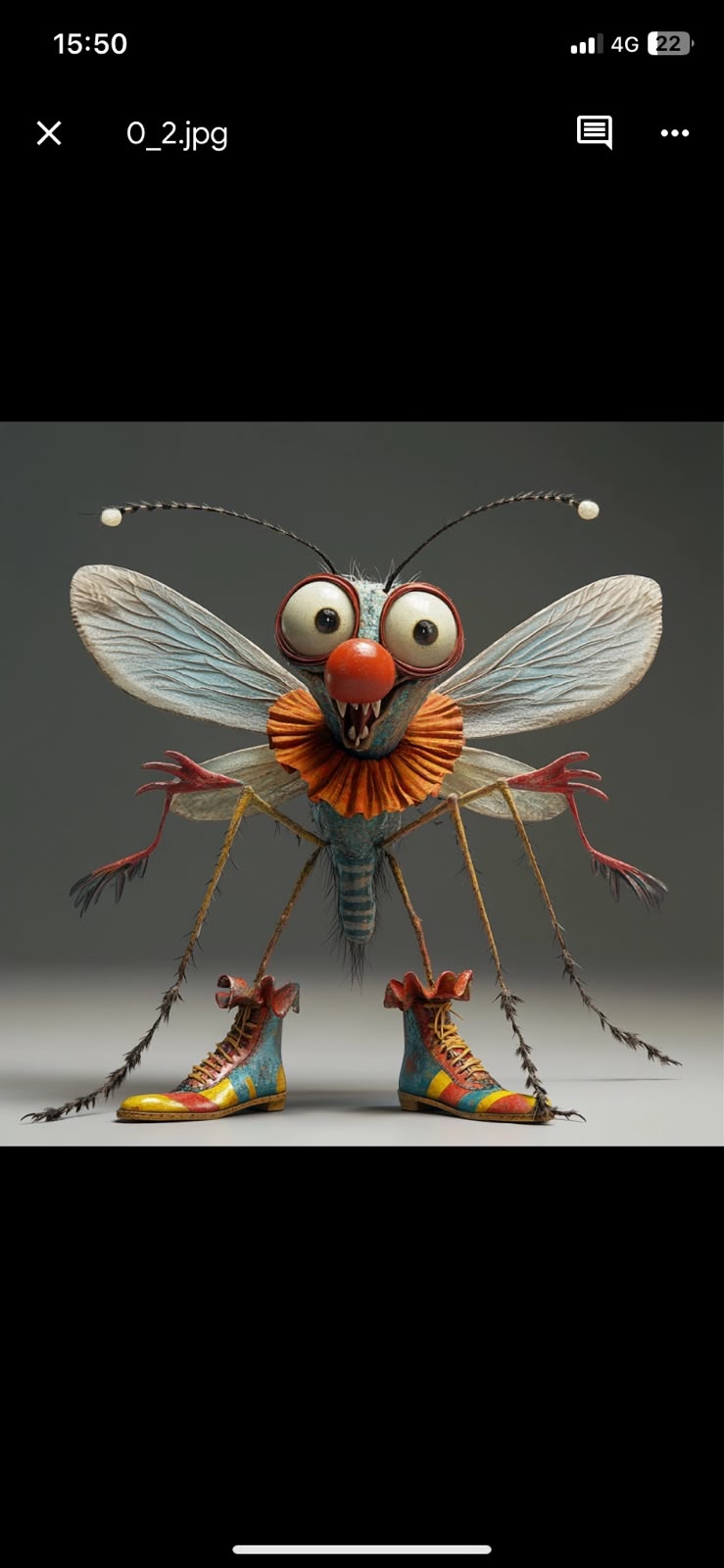 Skeeter, a wide-eyed mosquito with a red clown nose, orange collar, wings and colorful boots